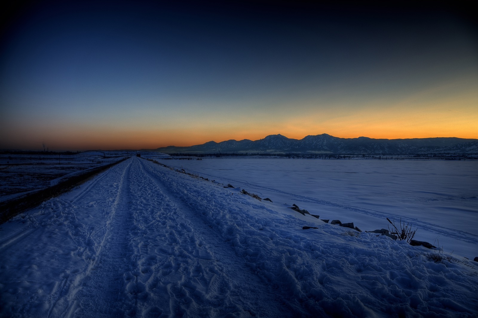 Boulder Reservoir at dusk in winter, the Flatirons on the horizon